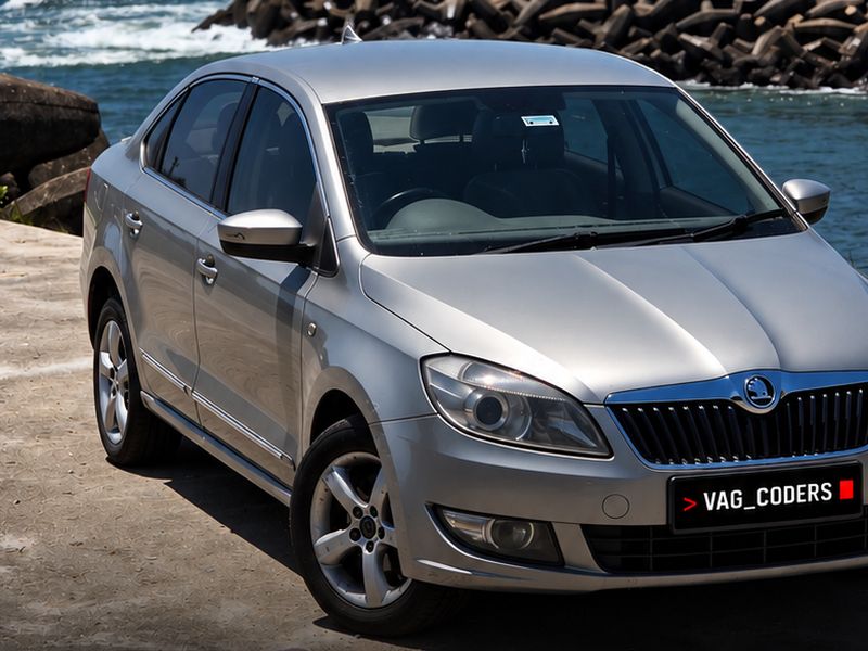 Silver Skoda Rapid 2014 by the sea in Colachel